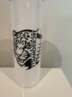 A white object with a black and white design featuring a stylized bird or bird-like figure.