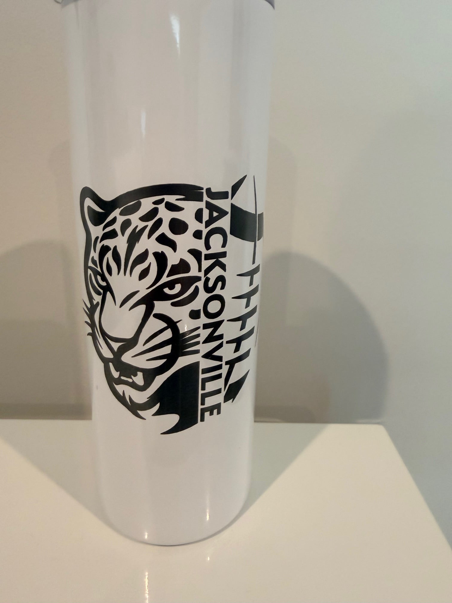 A white object with a black and white design featuring a stylized bird or bird-like figure.