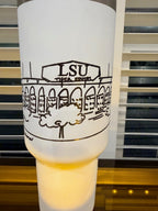 a white object with black text and graphics on it, which appears to be a decorative item or a piece of art.