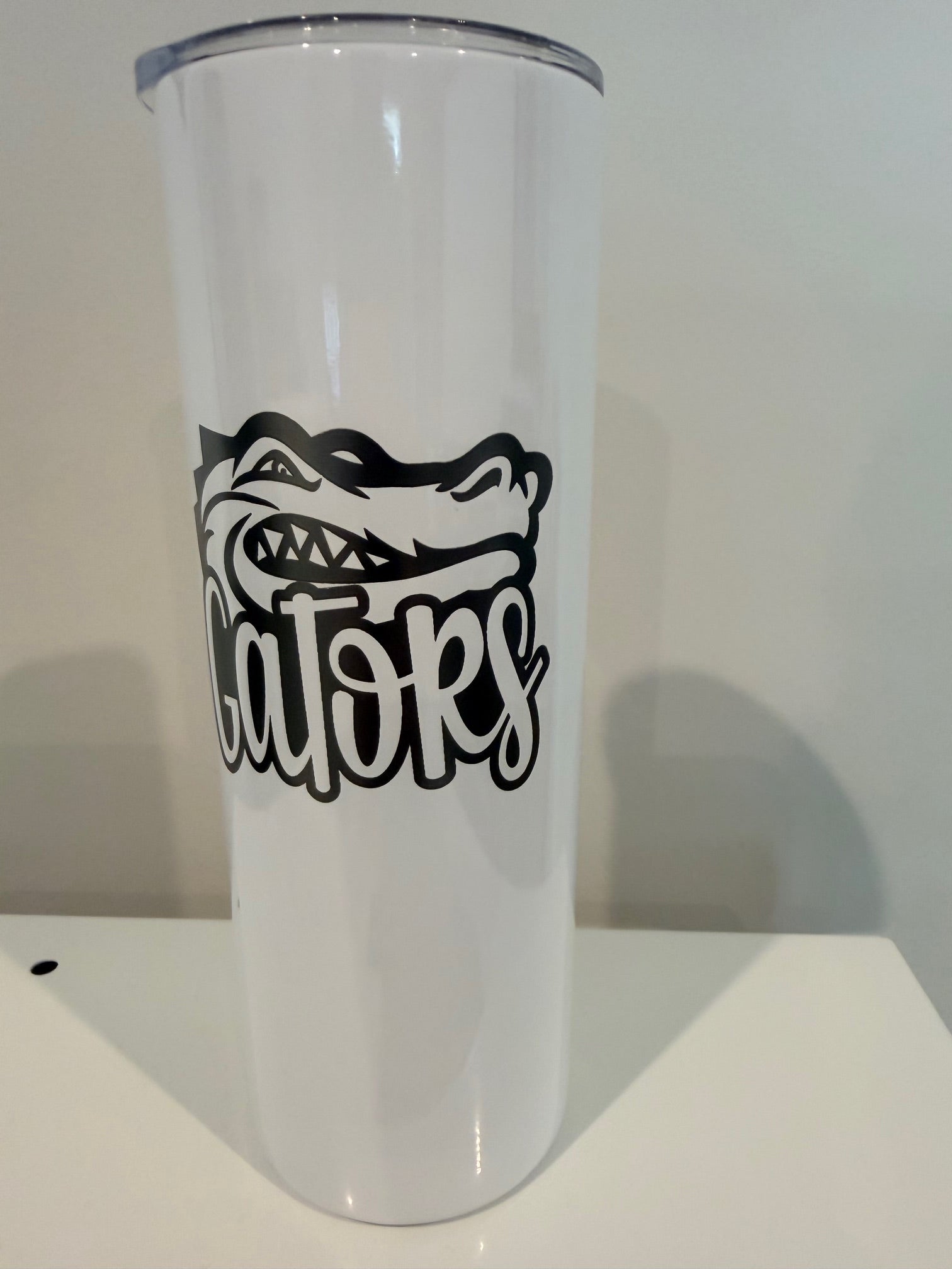 A white cylindrical object with a black graphic design on it.